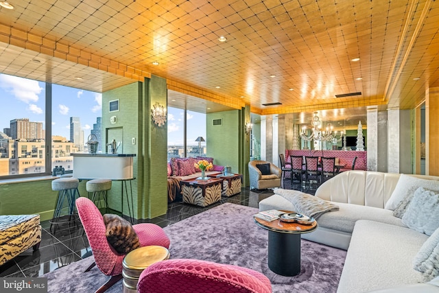 tiled living room with a notable chandelier