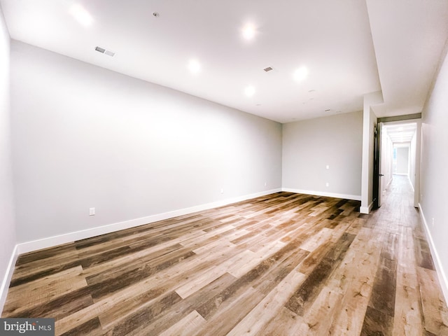 spare room with wood-type flooring