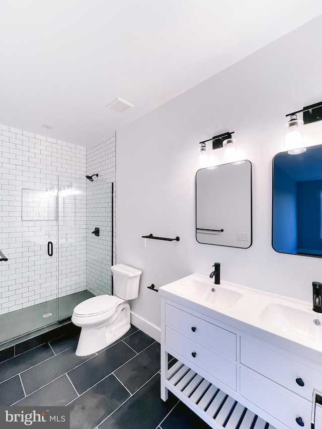 bathroom featuring vanity, toilet, tile patterned floors, and walk in shower