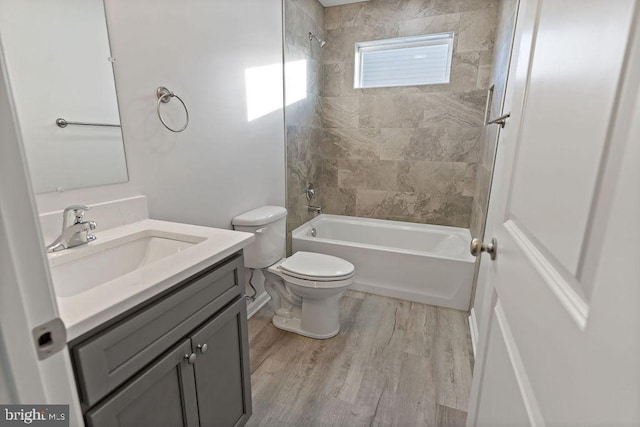 bathroom with shower / washtub combination, toilet, vanity, and wood finished floors