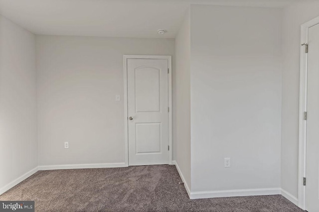 empty room with baseboards and carpet floors