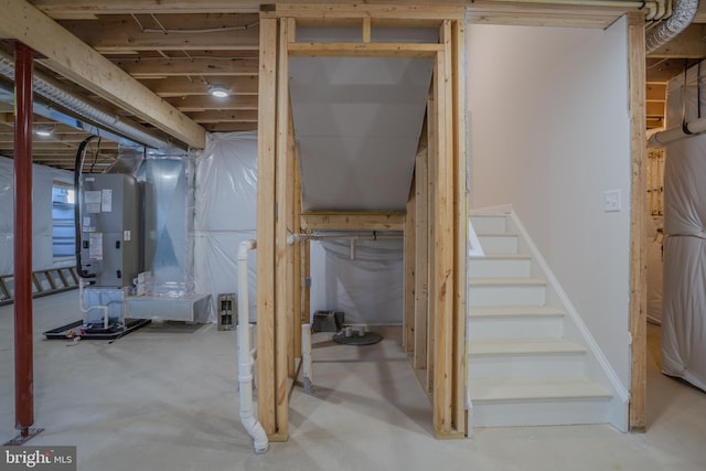 unfinished basement featuring stairs