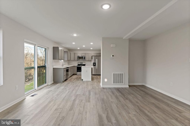 unfurnished living room with recessed lighting, baseboards, visible vents, and light wood-type flooring