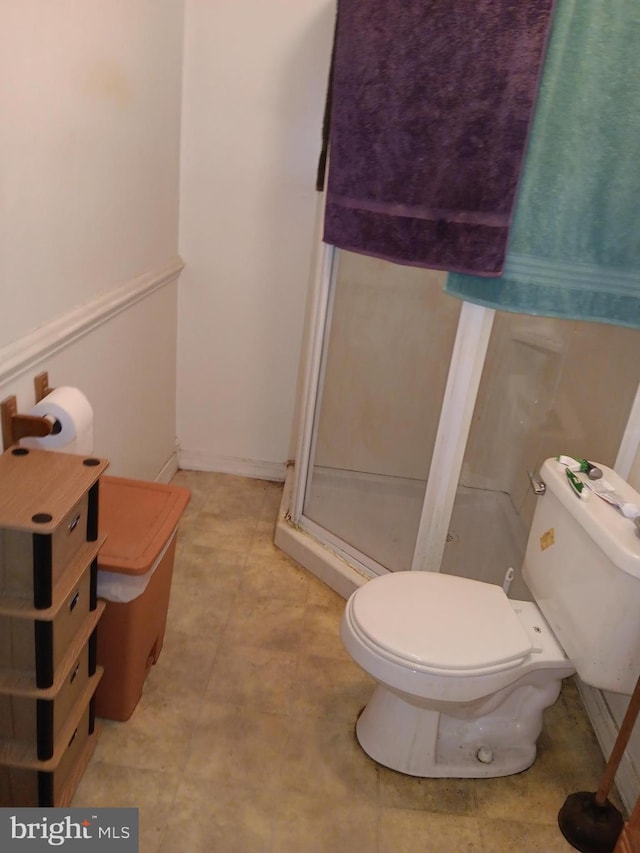 bathroom with toilet and walk in shower