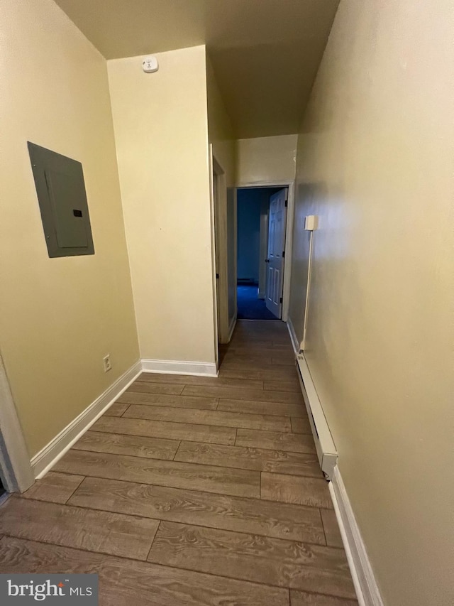 hall with electric panel, dark hardwood / wood-style floors, and baseboard heating