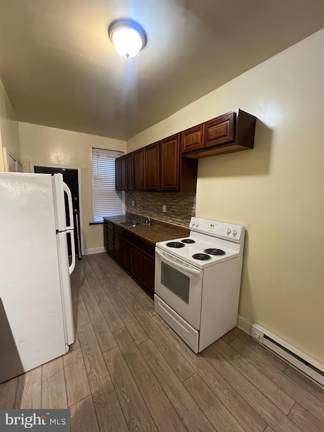 kitchen featuring white appliances, a baseboard heating unit, light hardwood / wood-style flooring, decorative backsplash, and dark brown cabinets