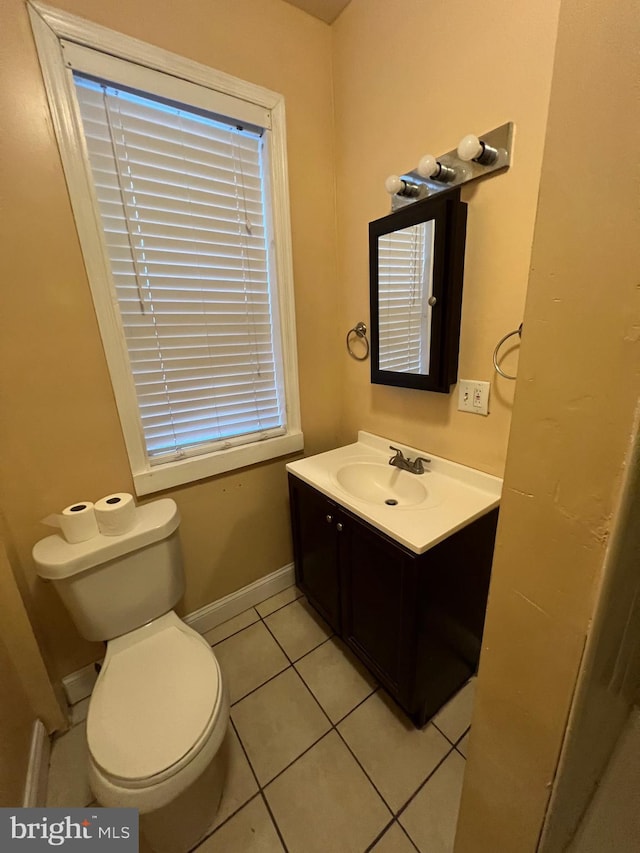 bathroom with tile patterned flooring, vanity, and toilet