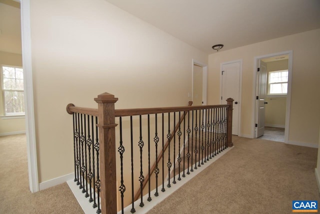 corridor featuring light colored carpet