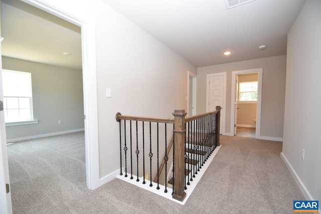 hallway with light colored carpet