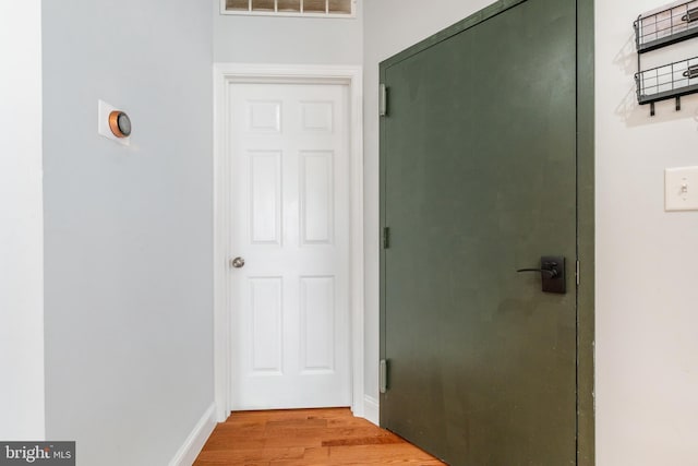 corridor with light hardwood / wood-style floors