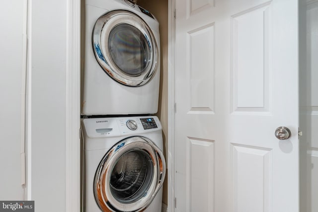 washroom with stacked washer / drying machine