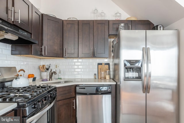 kitchen with sink, appliances with stainless steel finishes, dark brown cabinetry, and backsplash