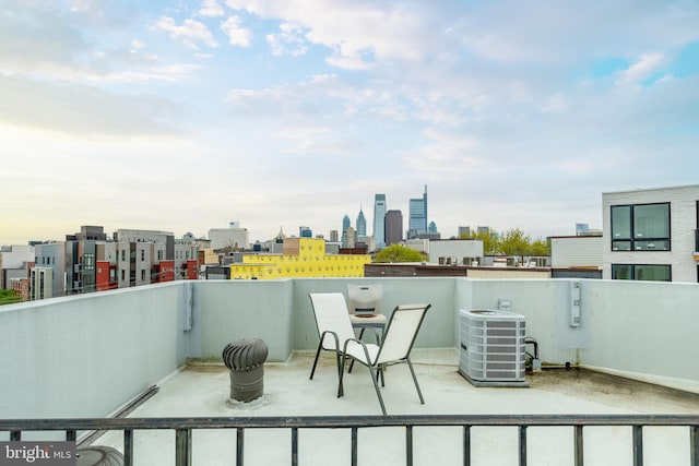 view of patio with a balcony and central AC unit