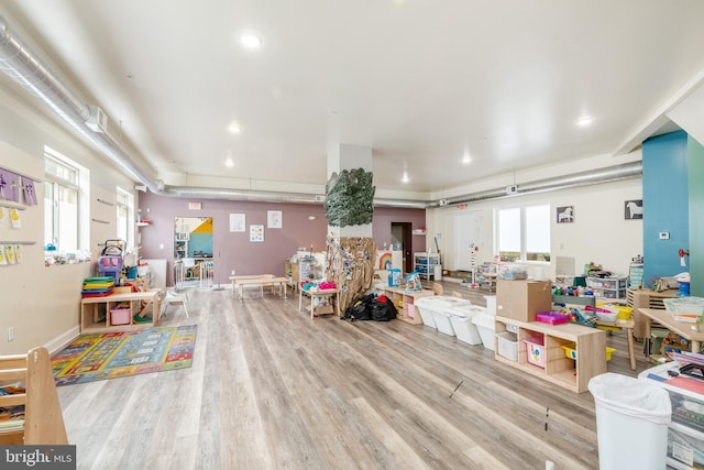 rec room with light hardwood / wood-style flooring and a healthy amount of sunlight