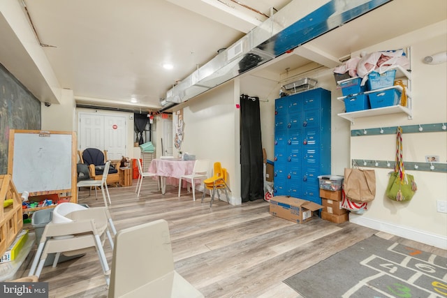 basement with hardwood / wood-style floors