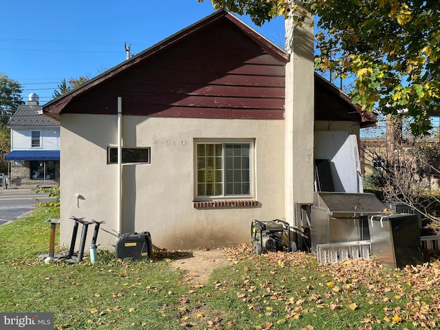 view of side of property with a lawn