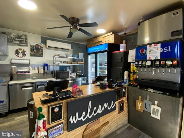 kitchen with a wall unit AC, wood-type flooring, and ceiling fan