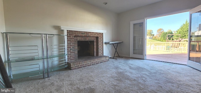 unfurnished living room with carpet floors and a fireplace