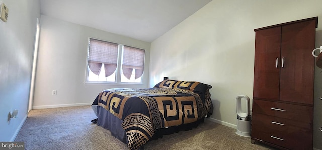 carpeted bedroom with vaulted ceiling