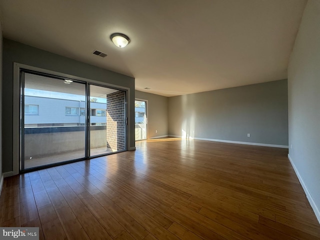 empty room with hardwood / wood-style floors