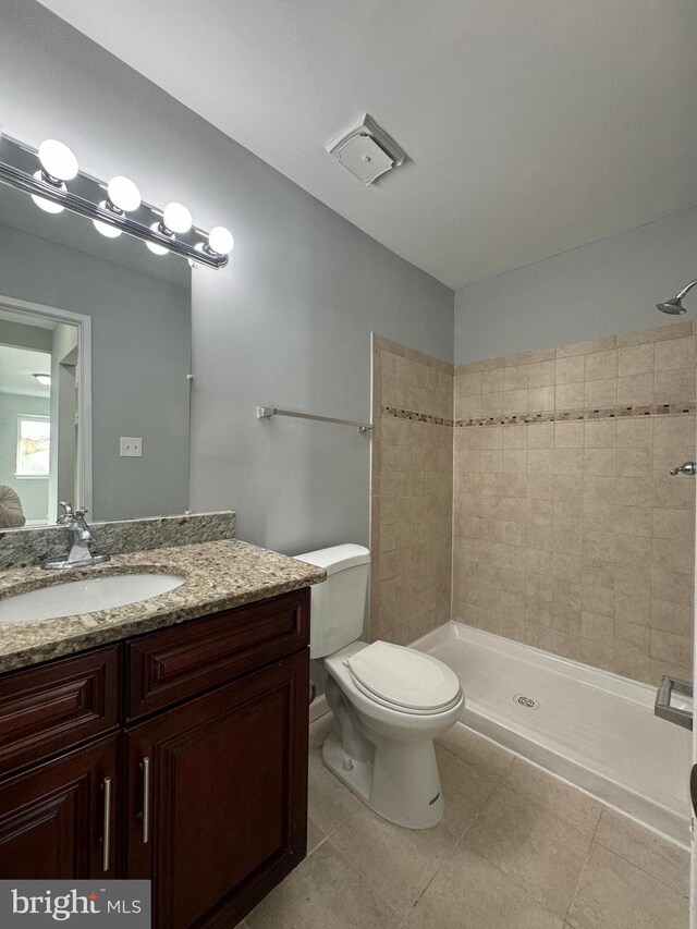 10204 Prince Pl Unit 3-308, Upper Marlboro, MD 20774 - bathroom with tile patterned floors, toilet, a tile shower, and vanity