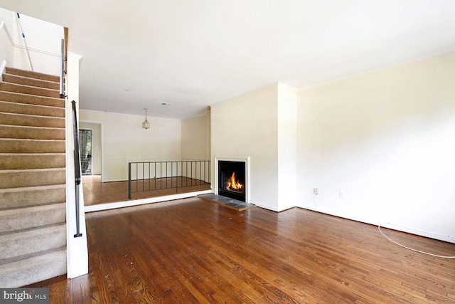 unfurnished living room featuring dark wood-type flooring