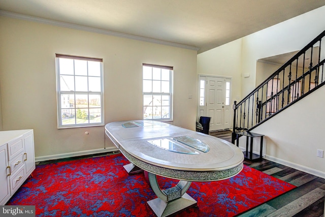 foyer entrance featuring crown molding, dark wood-type flooring, and plenty of natural light