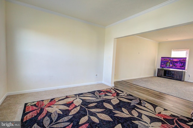 unfurnished living room with crown molding and hardwood / wood-style flooring