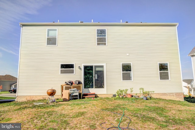 rear view of house featuring a lawn