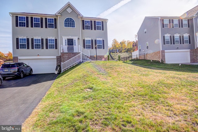 view of front facade with a garage and a front lawn