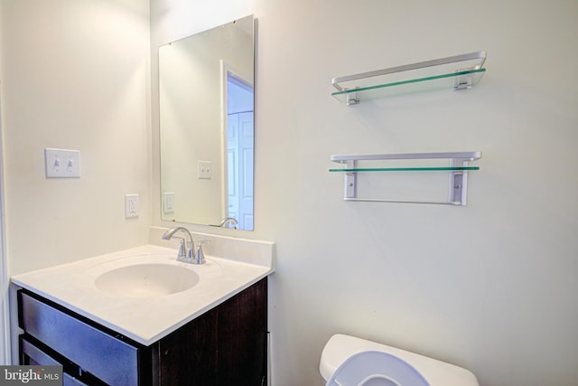 bathroom featuring toilet and vanity