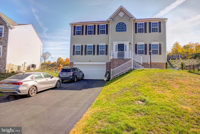 view of front facade featuring a front yard and a garage