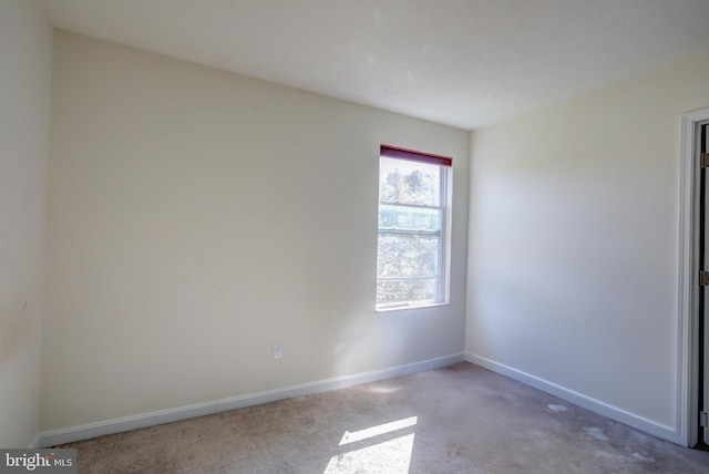 unfurnished room with light colored carpet