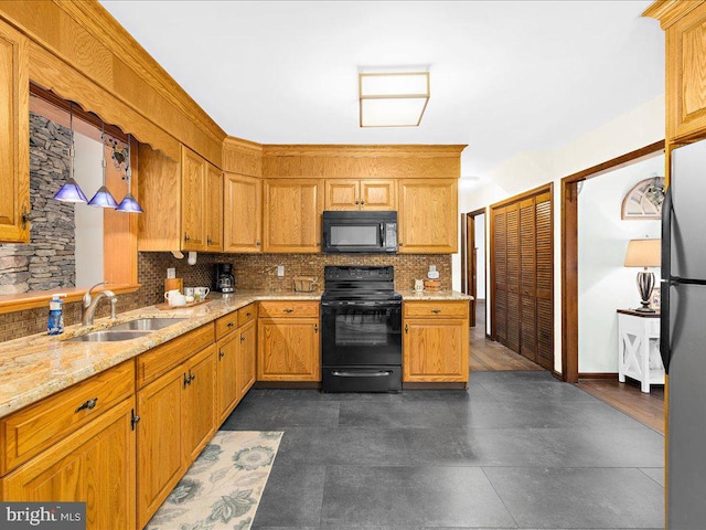 kitchen with black appliances, backsplash, dark hardwood / wood-style flooring, light stone countertops, and sink