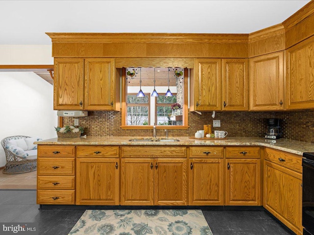 kitchen featuring light stone countertops, sink, and tasteful backsplash