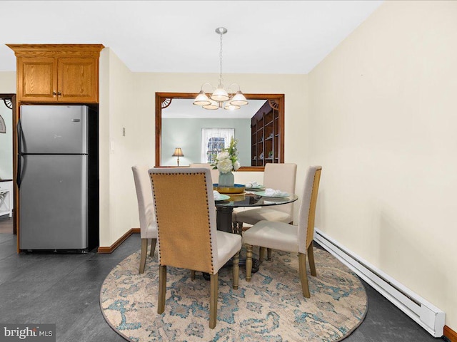 dining space featuring a chandelier and a baseboard radiator