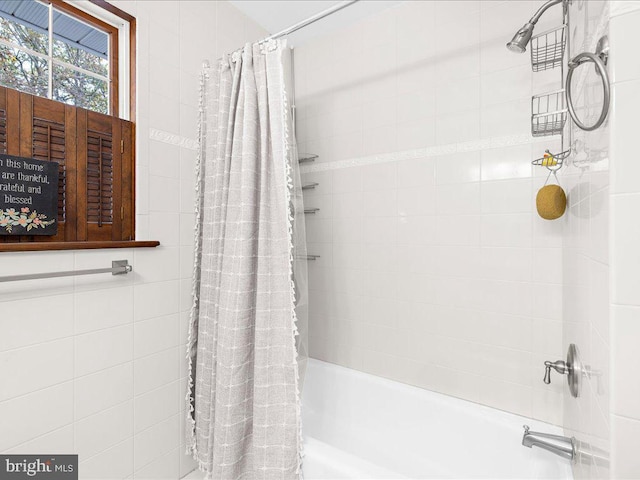 bathroom featuring shower / bathtub combination with curtain