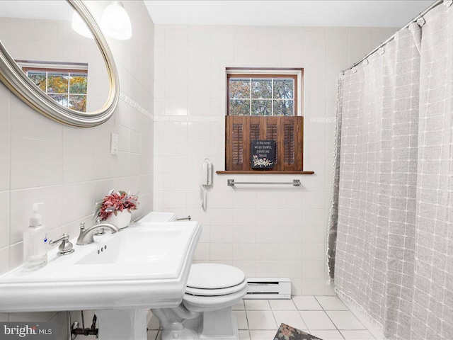 bathroom with tile walls, a baseboard heating unit, tile patterned flooring, and toilet