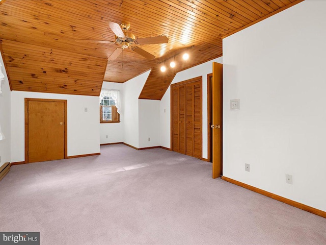 additional living space featuring wood ceiling, vaulted ceiling, light colored carpet, and ceiling fan