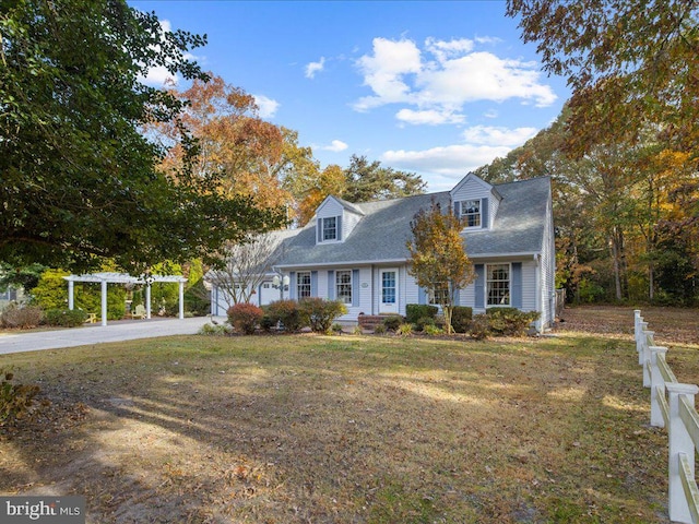 new england style home featuring a front yard and a pergola