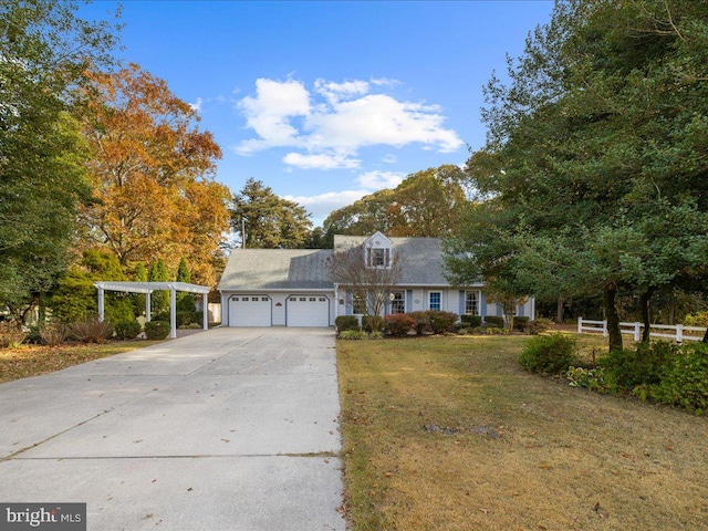 view of front of property with a garage and a front lawn