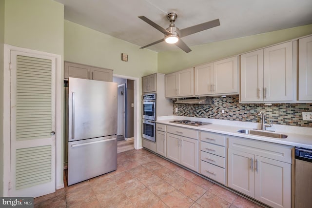 kitchen with stainless steel appliances, sink, ceiling fan, light tile patterned floors, and decorative backsplash