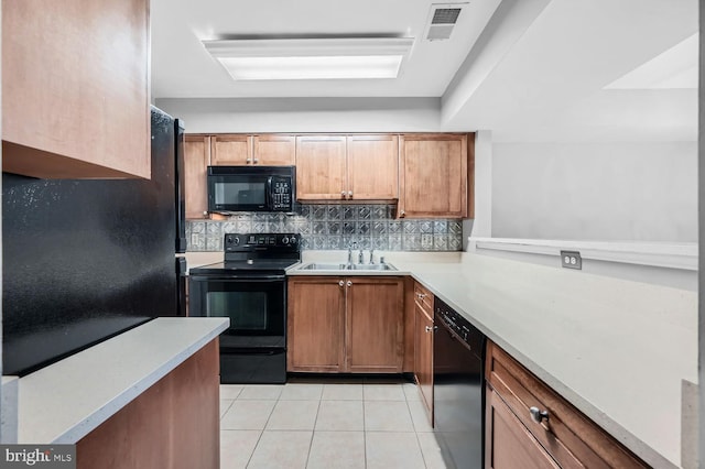 kitchen featuring black appliances, sink, backsplash, and light tile patterned floors