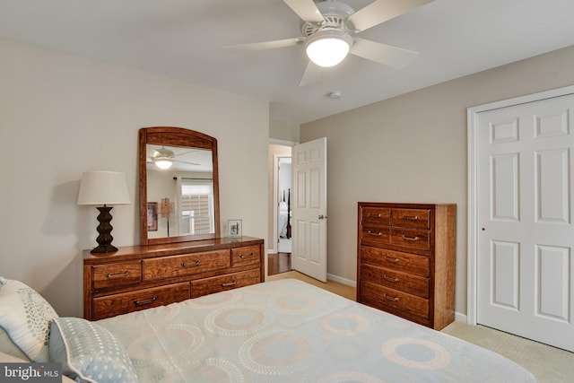 bedroom featuring light carpet and ceiling fan