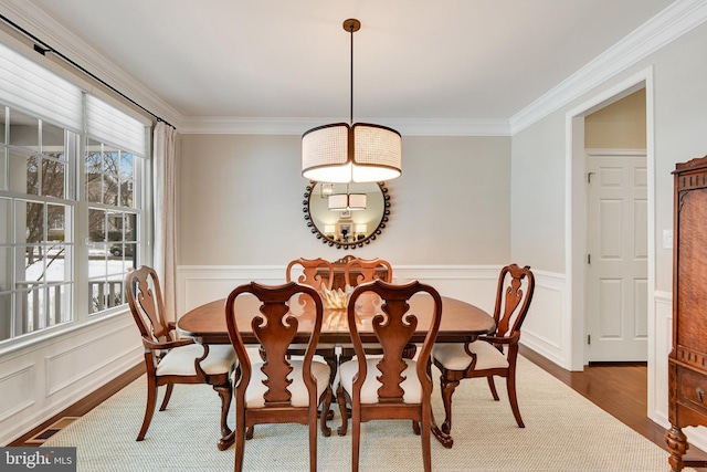 dining space with dark hardwood / wood-style flooring and ornamental molding