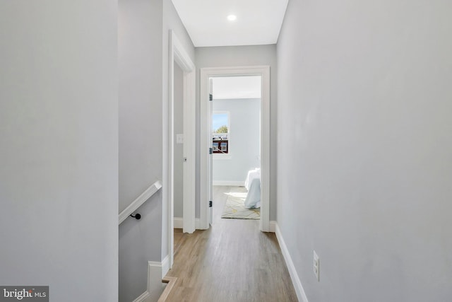 hallway with light hardwood / wood-style floors