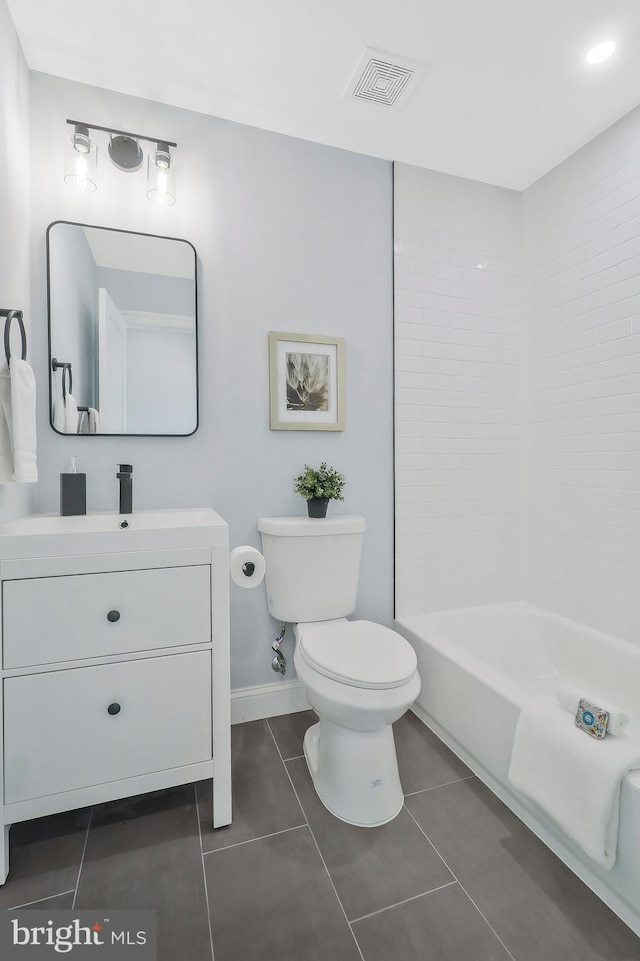 bathroom featuring vanity, toilet, and tile patterned flooring