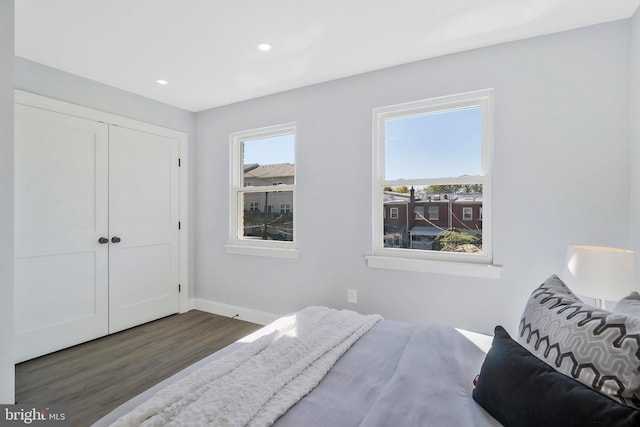 bedroom featuring a closet and dark hardwood / wood-style flooring