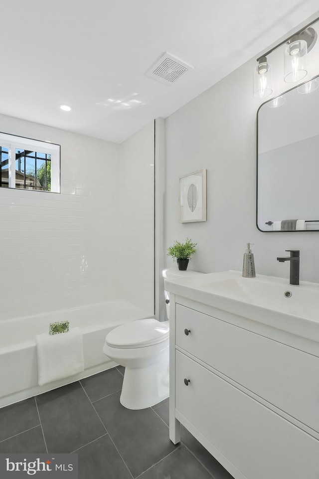 bathroom with vanity, toilet, and tile patterned floors