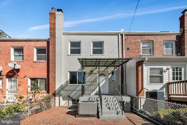 back of property featuring a patio area, central AC unit, and a pergola